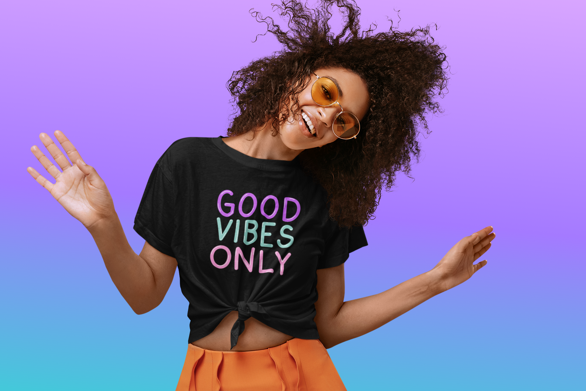 Happy black woman wearing a black Good Vibes Only t-shirt.