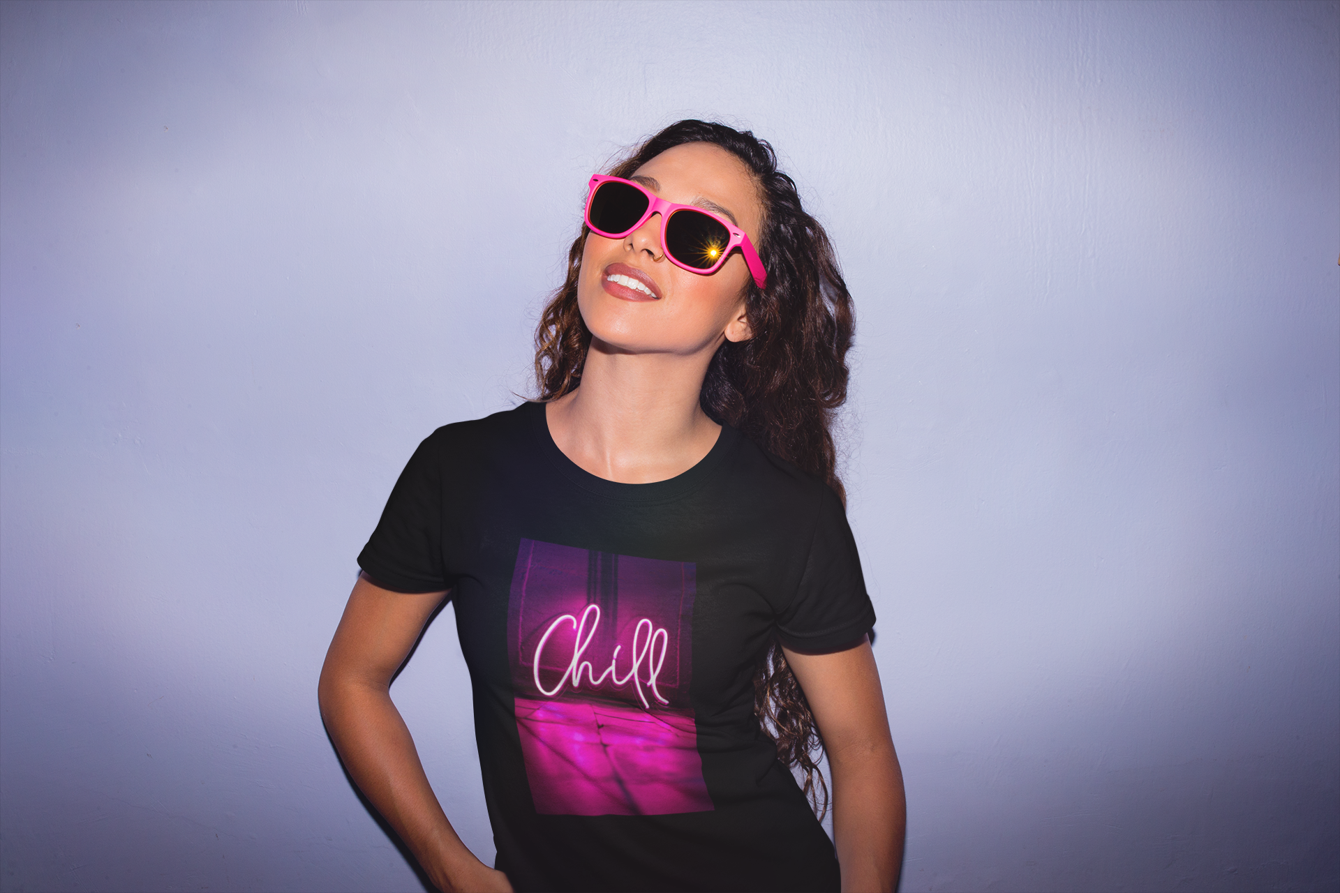 Cool woman wearing neon pink chill sign with sunglasses.