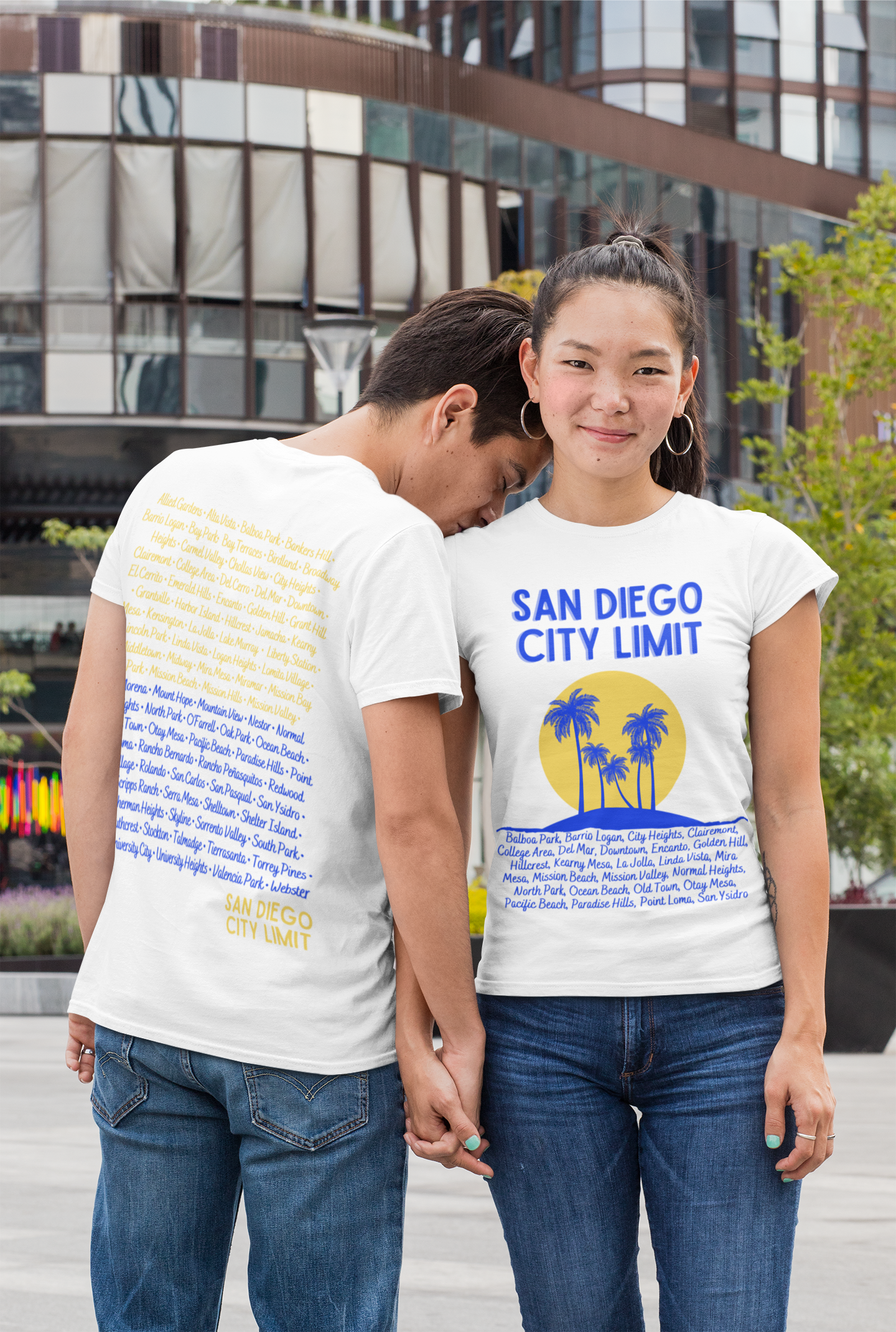 A couple wearing matching short sleeve t-shirts with print on the front and back.